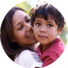 A mother and her young son cheek to cheek, in a round frame