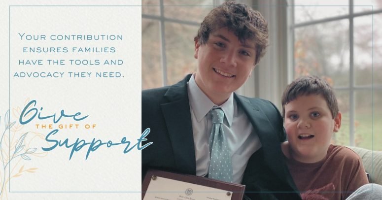 A card reading ‘Give the Gift of Support’ beside a photograph of a young man and a boy