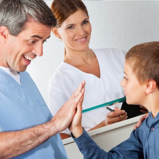 A man, a woman and a boy high-fiving across a table — the design's square window on resource-card-1